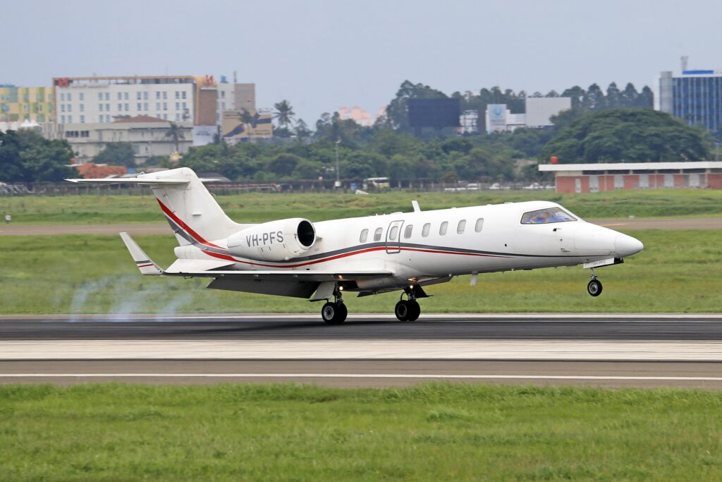 A white and red 45xr landing on the runway