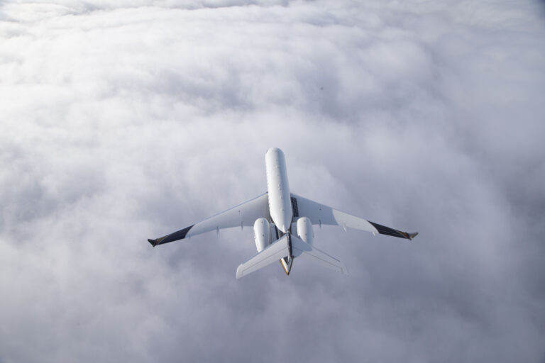 Global Express aircraft flies over the clouds