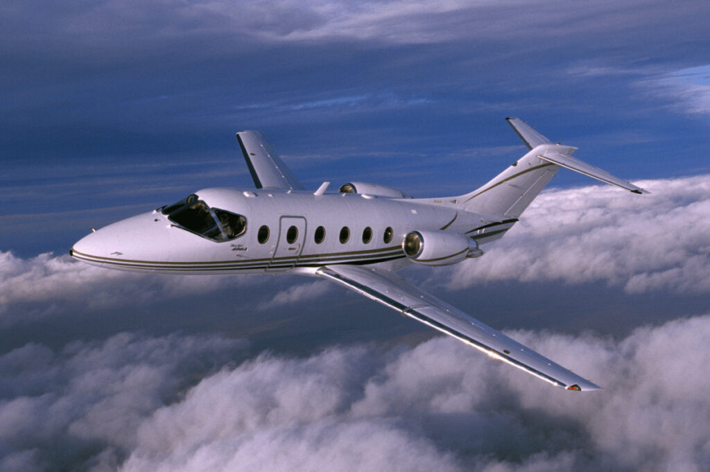 Beechcraft airplane flying above the clouds