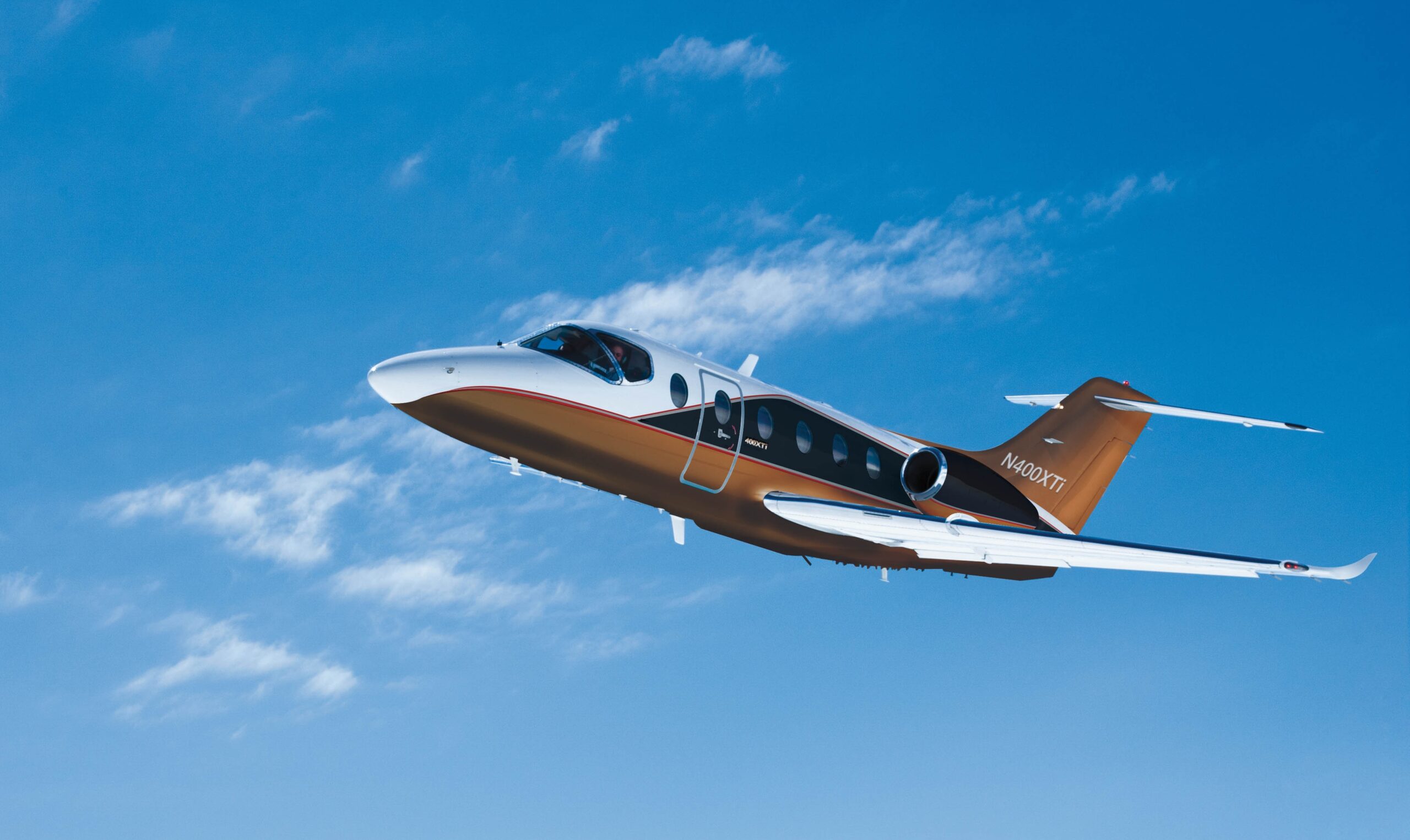 Nextant aircraft flying through blue skies